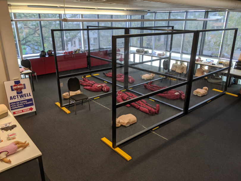 First-aid safety training room with perspex screens separating manikins. 