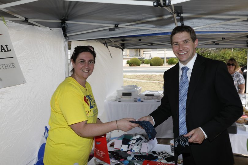 Raffy and Alistair Coe shaking hands at the fundraising breakfast for ACT Down Syndrome