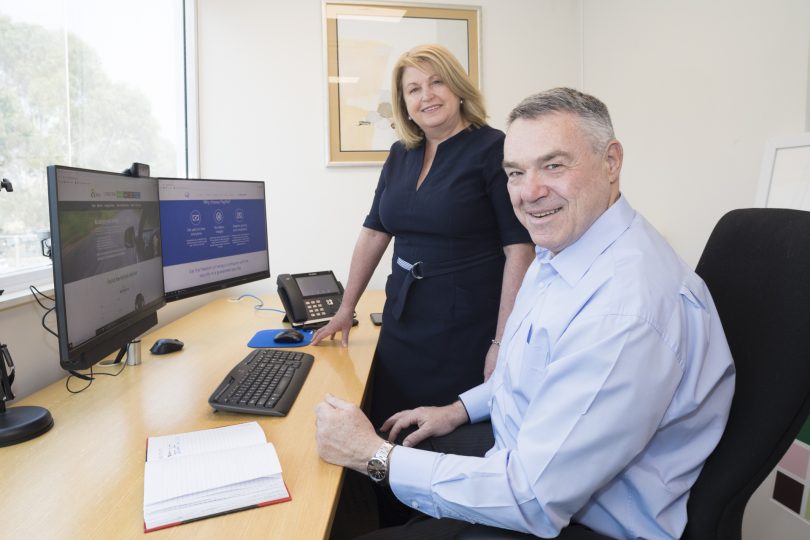 Ian and Maria Lindgren at desk in PayMe Group office.