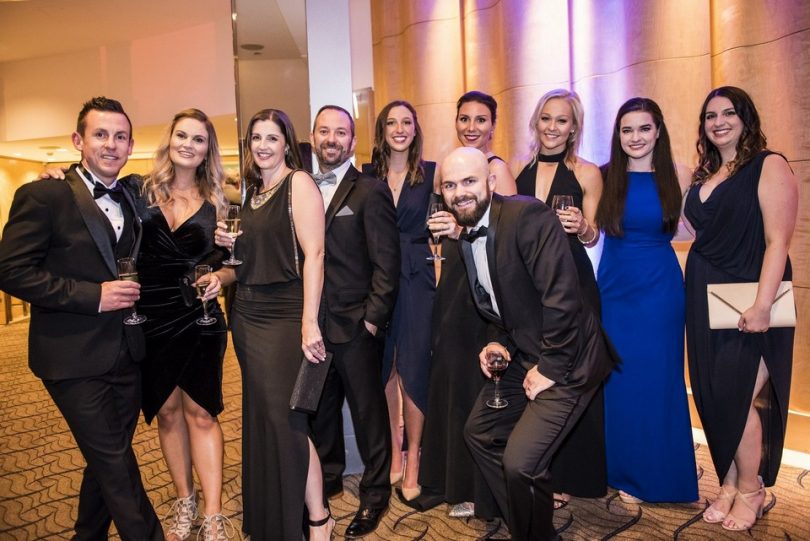 Lara Morgan (second from left) and the Allinsure team posing at a formal event.