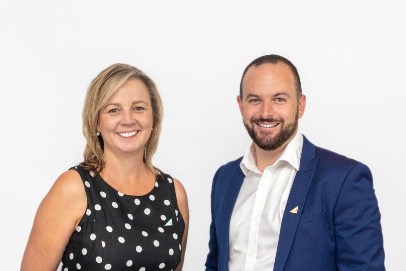 Real estate agents Fiona Murray and Jonny Warren, smiling against white background.