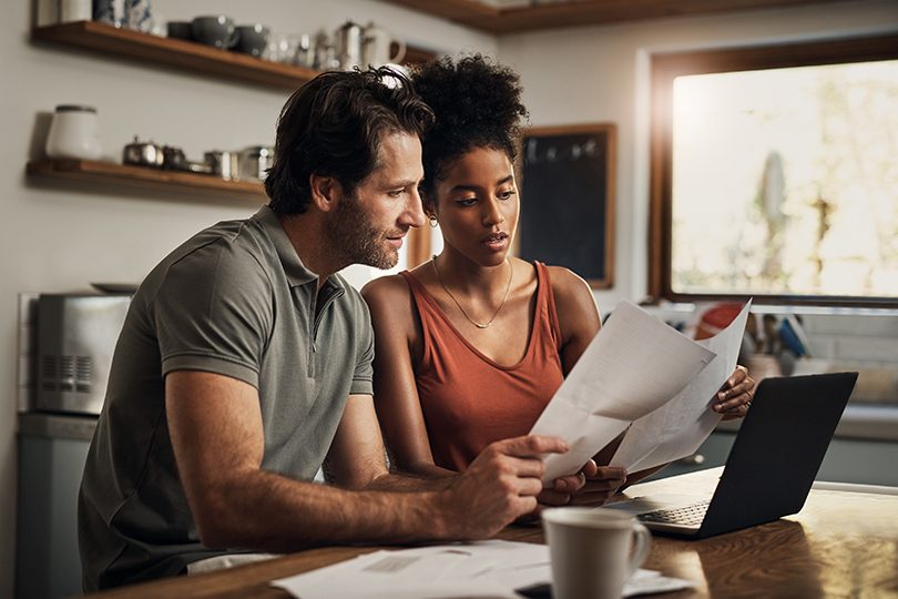 Man and woman sitting at table doing tax return.