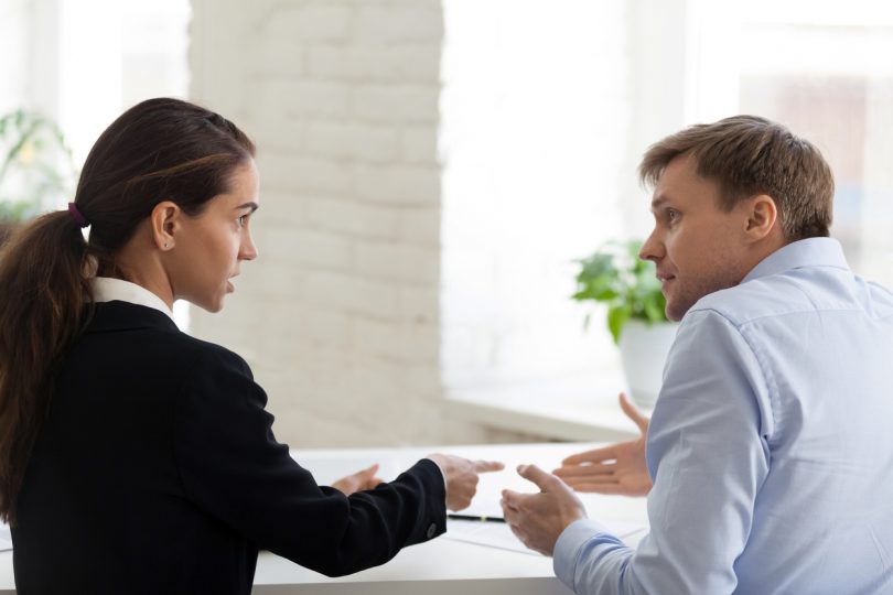 Woman and man in discussion at office.