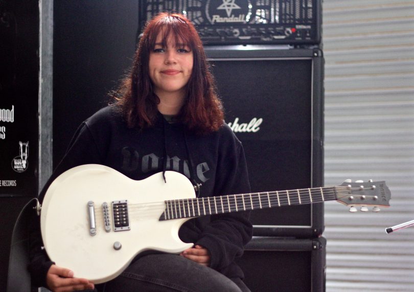 Liv McMahon holding guitar.