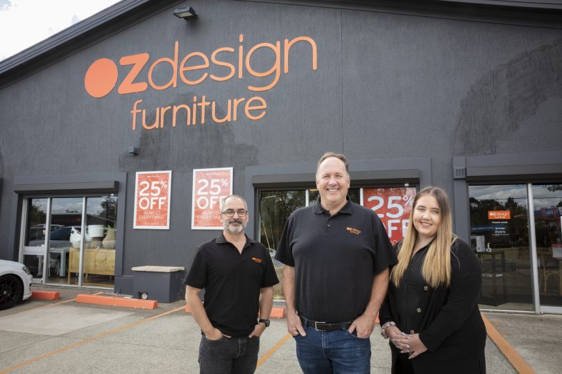 Peter Bond standing out the front of OZ Design Furniture Fyshwick with staff members Adam and Alexandra