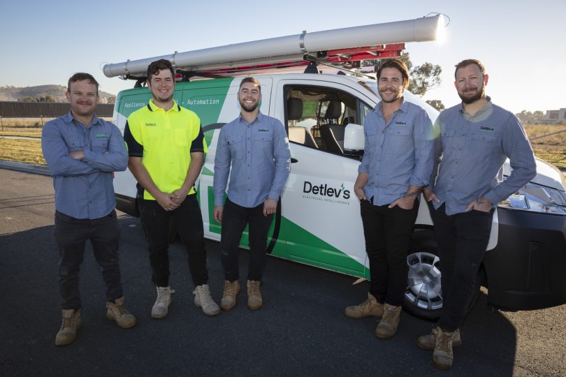 The Detlev's team standing in front of their van