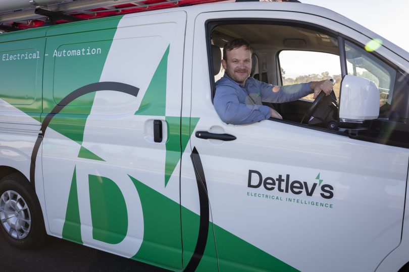 Grae Munroe sitting in Detlev's electrical services van