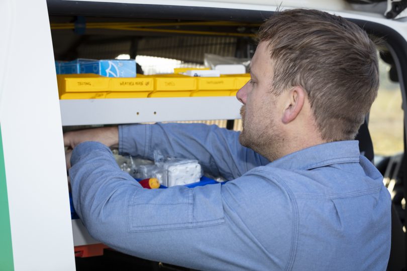 Grae Munroe finding parts on shelf in Detlev's electrical services van
