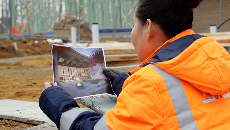 Woman reading a plan on construction site