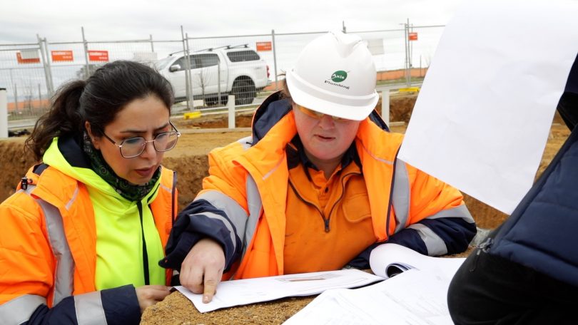 Two women working on construction site