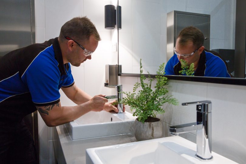 Plumber working on sink 