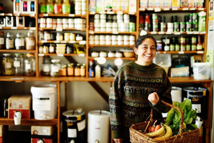 Woman in The Food Co-op holding basket of food