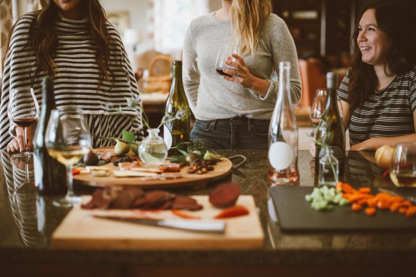 People standing around a dinner table