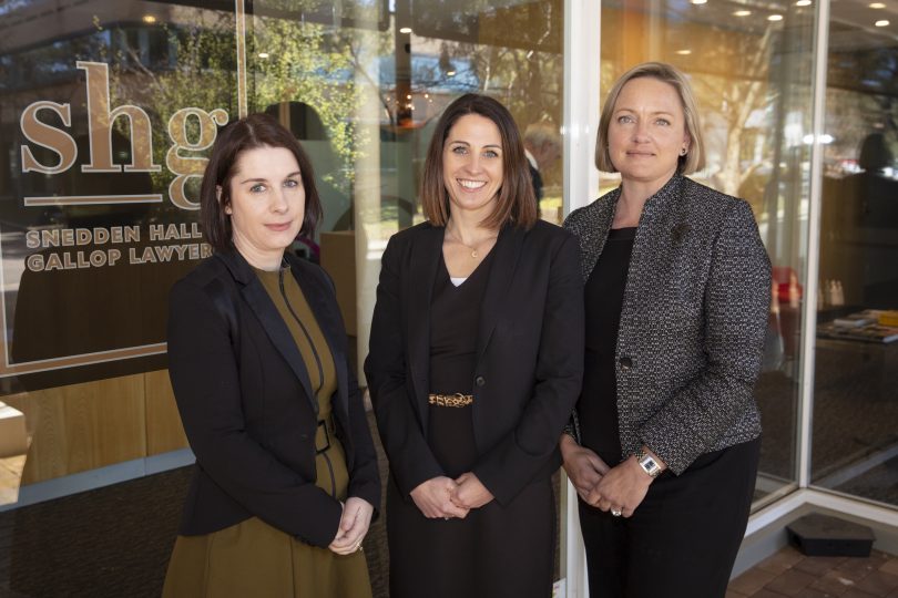 Amber Wang, Emily Shoemark and Julia Bridgewater standing outside Sneddon Hall and Gallop Lawyers office