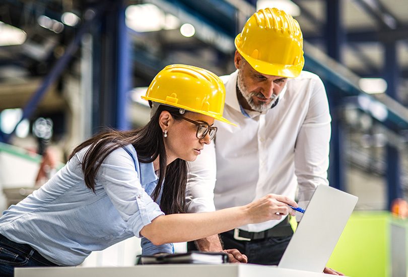 Man and woman at work in light industrial warehouse