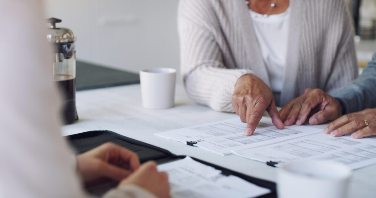 Cropped shot of a senior couple meeting with a consultant to discuss paperwork at home