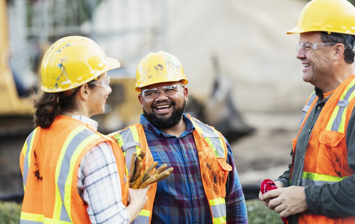 Workers talking in high vis vests on a construction site