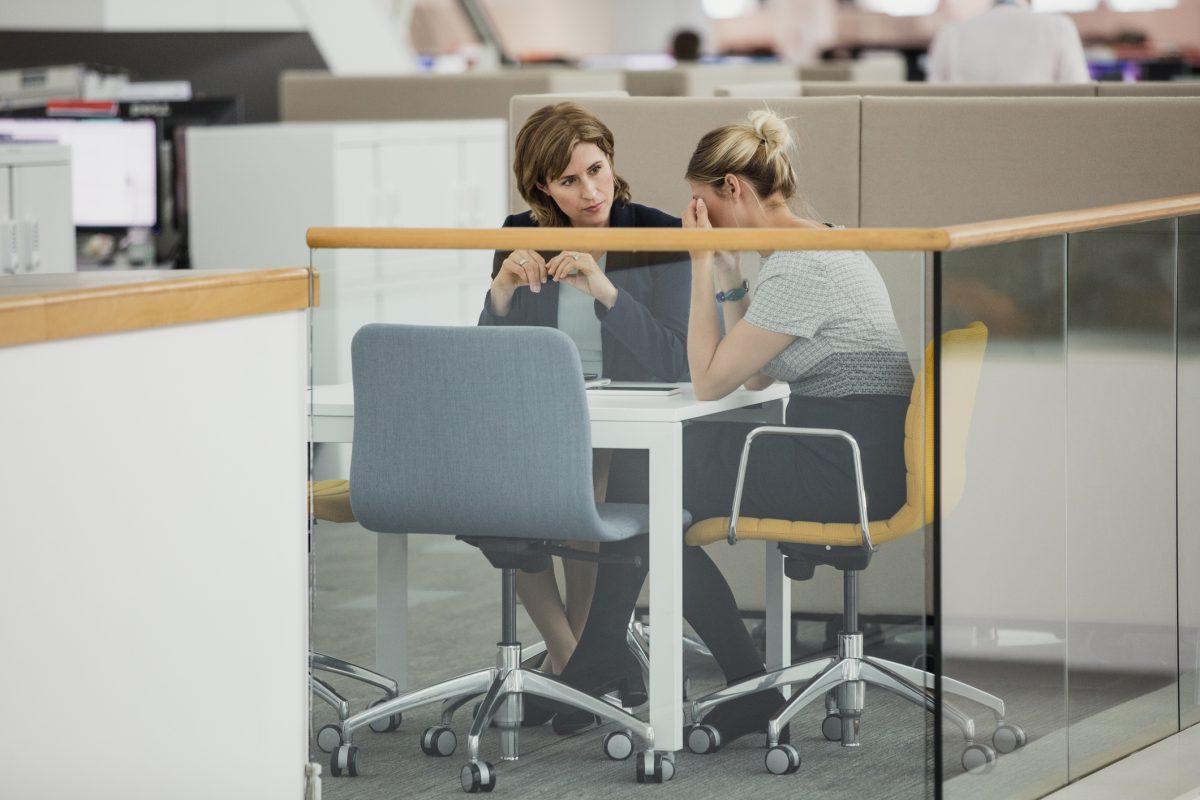 Two female colleagues having a meeting with one upset